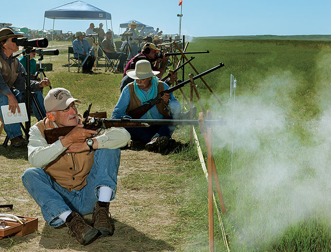 <em>A rifle recoils in a cloud of smoke on a shot taken from a sitting position</em>