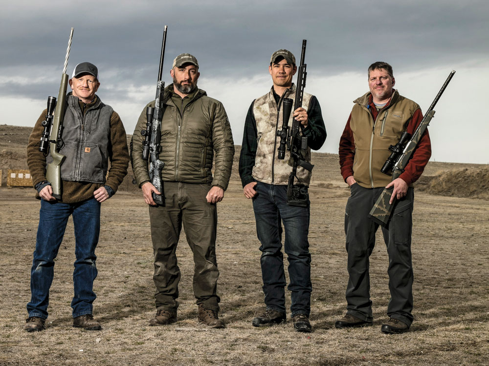 four men holding rifles