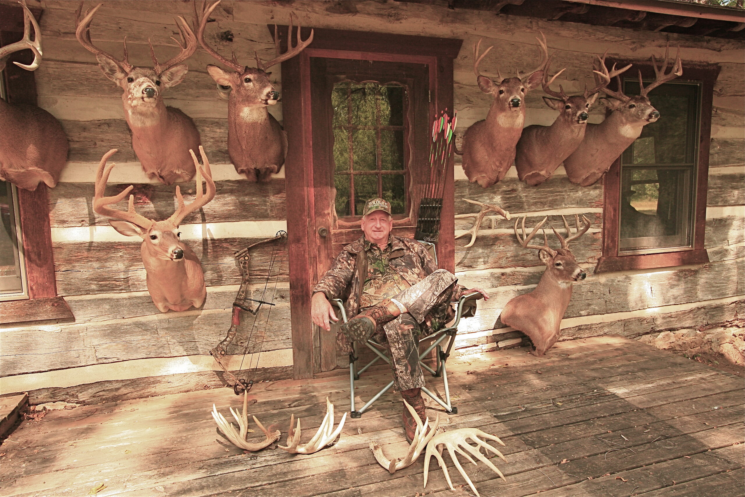 <em>Jim Brush of Galesville, Wis., poses with some of his trophy whitetails taken while bowhunting from the ground.</em>