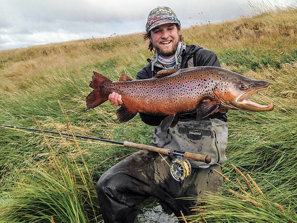 david burgher holding a massive argentine brown trout