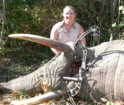 Elation, as Teressa recovers the first elephant ever downed by a female archer. The estimated 10,000-pound animal stood 12 feet tall at the shoulder, with tusks measuring 43 and 42 inches.