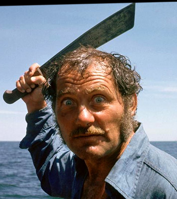 <strong>Frank Mundus = Quint</strong><br />
As Mundus's records grew, so did his reputation. And it wasn't always good. Mundus was widely known for his explosive temper and volatile disposition. Even in the 1970s, with clients paying him an astronomical $1,500 a day, he would often belittle them to the point of nervous breakdown. He was coarse and had a dangerous affection for whiskey and often sat on the bridge of his boat with a Tommy gun across his lap.