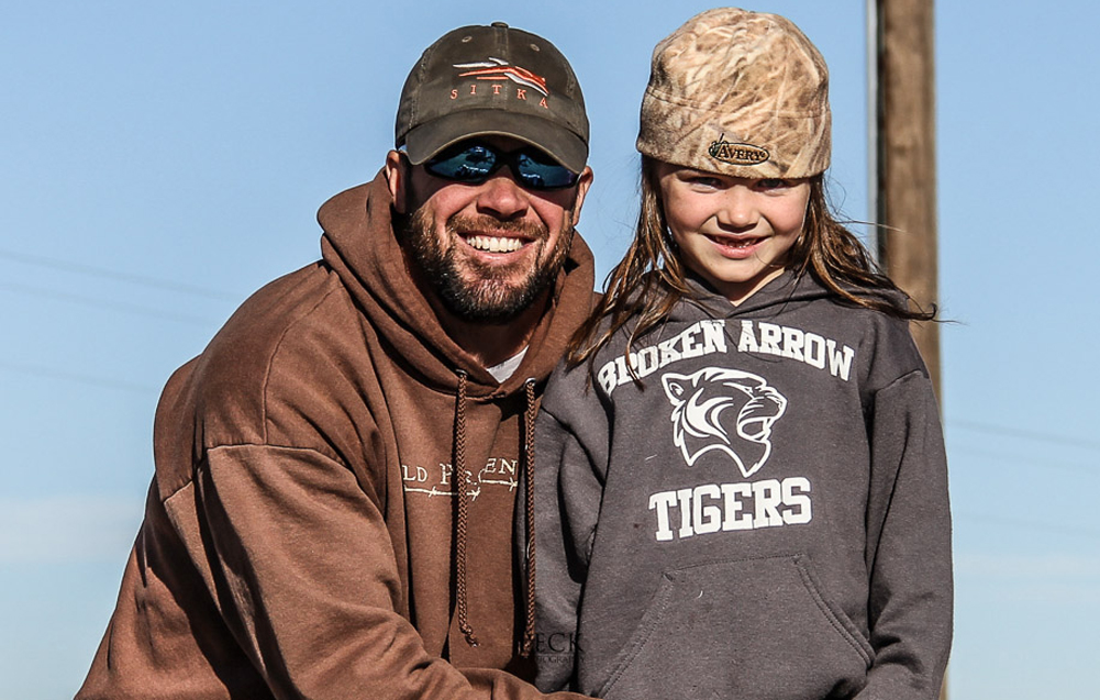 <em>Kip Peck with his daughter Timber. “Shannon saw my Facebook cover photo of a turkey and my profile picture with my daughter, and thought, ‘Well hell, he can’t be that bad,’” Peck said.</em>