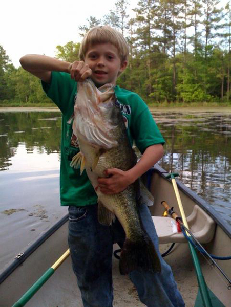 46. Eight-year-old Benjamin Dendy with a Georgia largemouth that is almost as big as he is. Posted by:gatrky