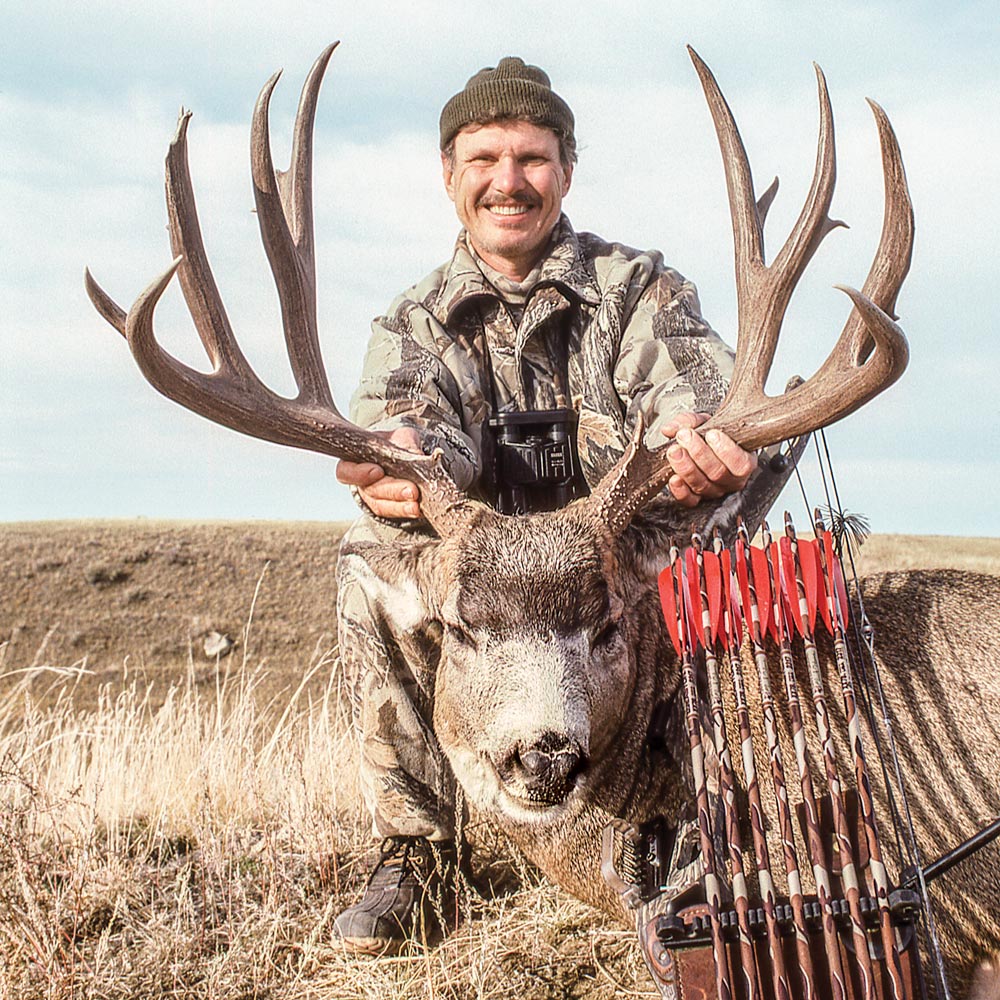 chuck adams with large record mule deer buck