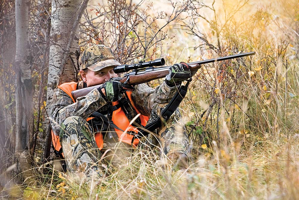 Montana Deer Hunter aiming with Scope