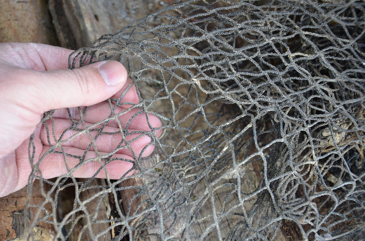 <strong>Start with the Net</strong><br />
The net is the basis for this project, and it should be of good quality. If you live in an area with a lot of commercial fishing, you may be able to pick up net scraps for free. And if you're nowhere near the sea, hit a craft store and buy a decorative fishing net. These are usually big enough for a decent ghillie net, appropriately colored (meaning dark), and reasonably priced. You could also weave your own net, if you have the time and plenty of thin cordage.