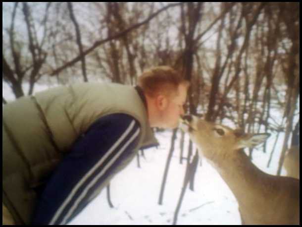 man kissing deer