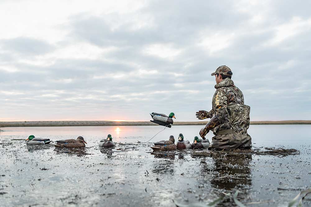 hunter tossing out duck decoys