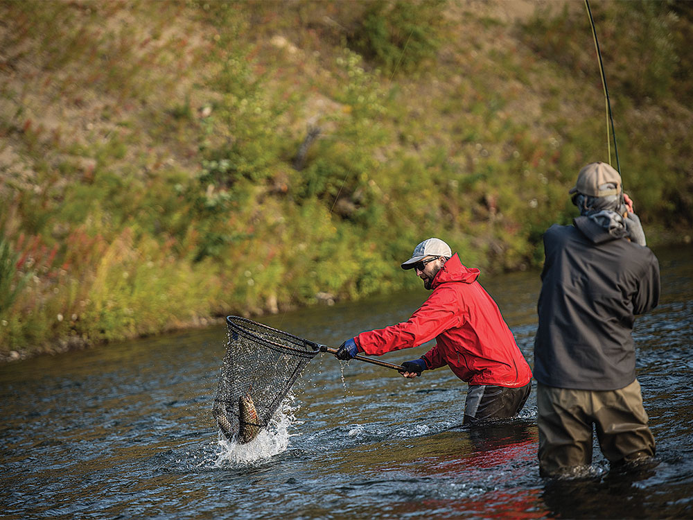 two anglers fishing for rainbow trout on the kamchatka river