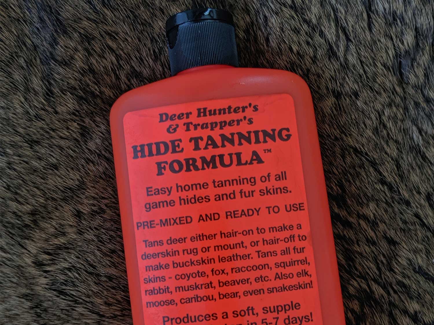 a red bottle of hide tanning formula