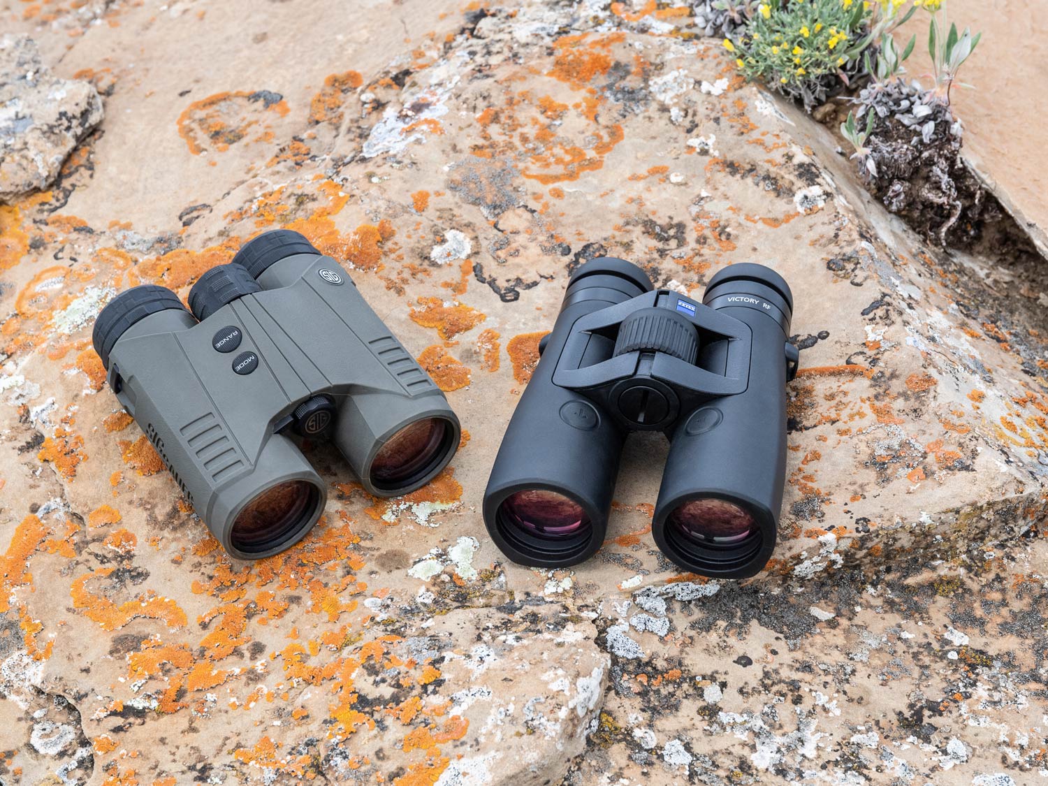 two rangefinding binoculars on a rock