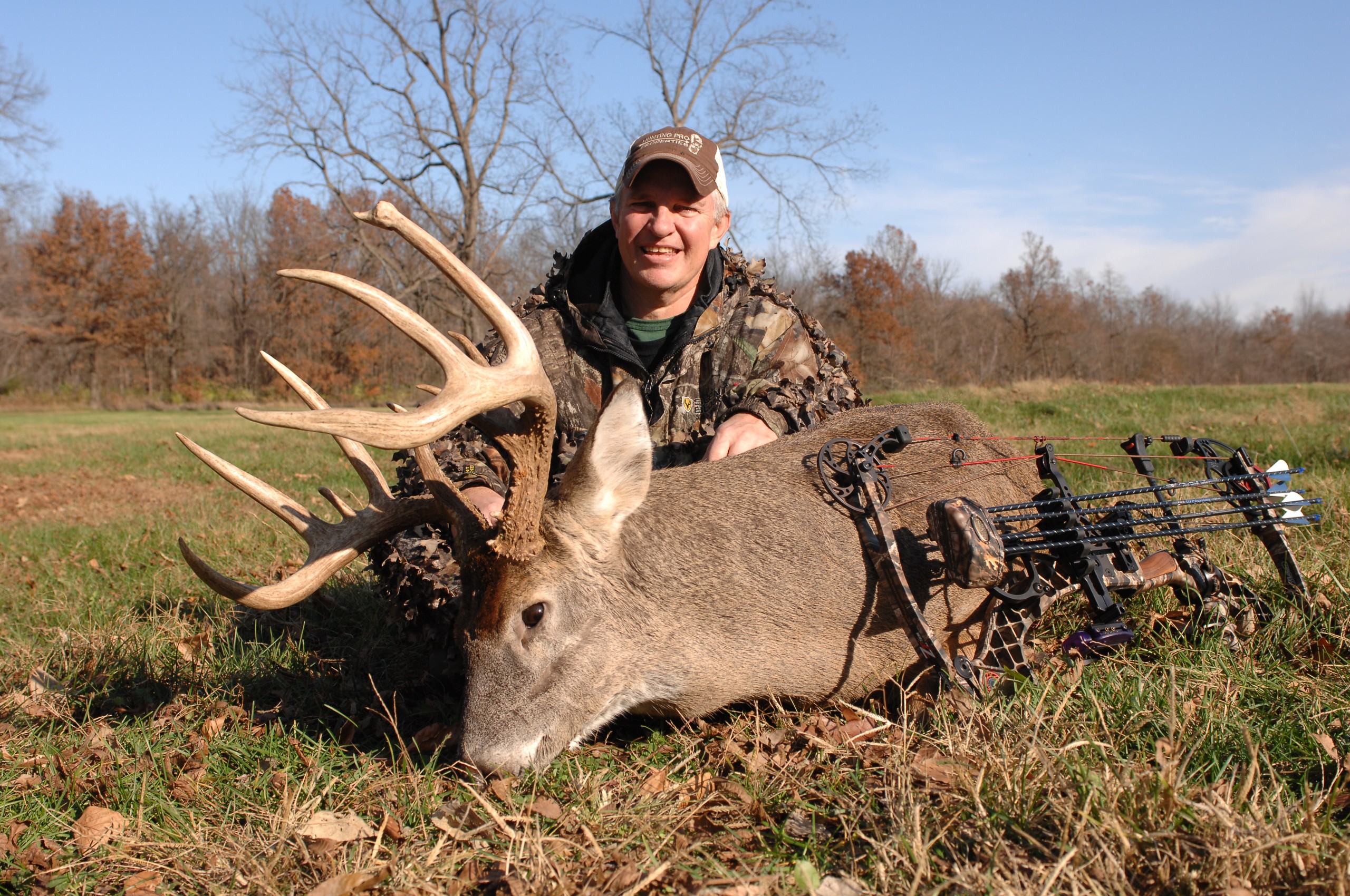 buck on the ground with hunter