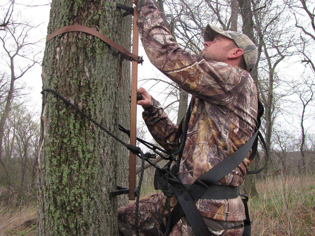 Hunter climbing a tree