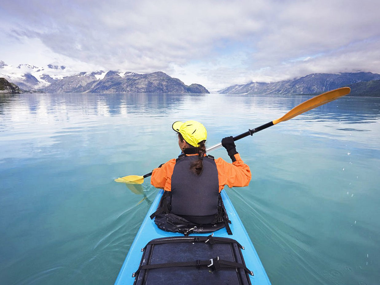 Woman kayaking over clear blue water