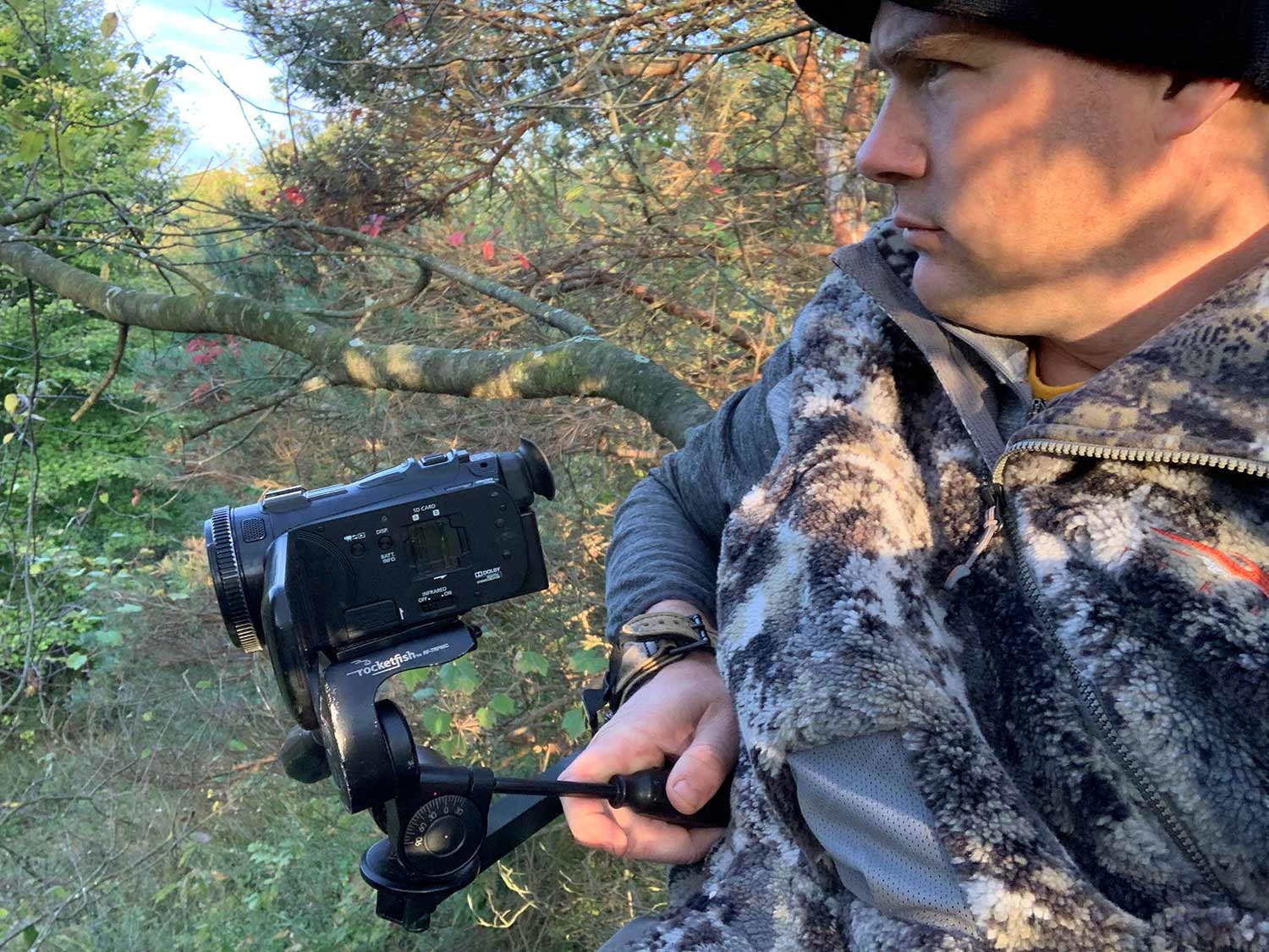 Hunter setting up a camera for a hunt