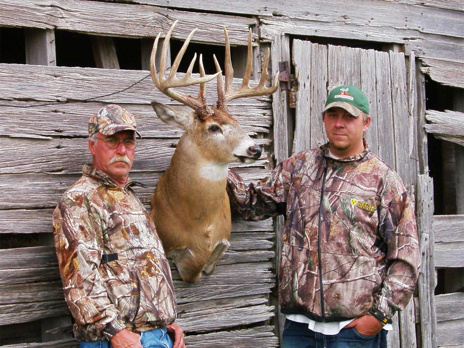 hunters beside a trophy whitetail buck.