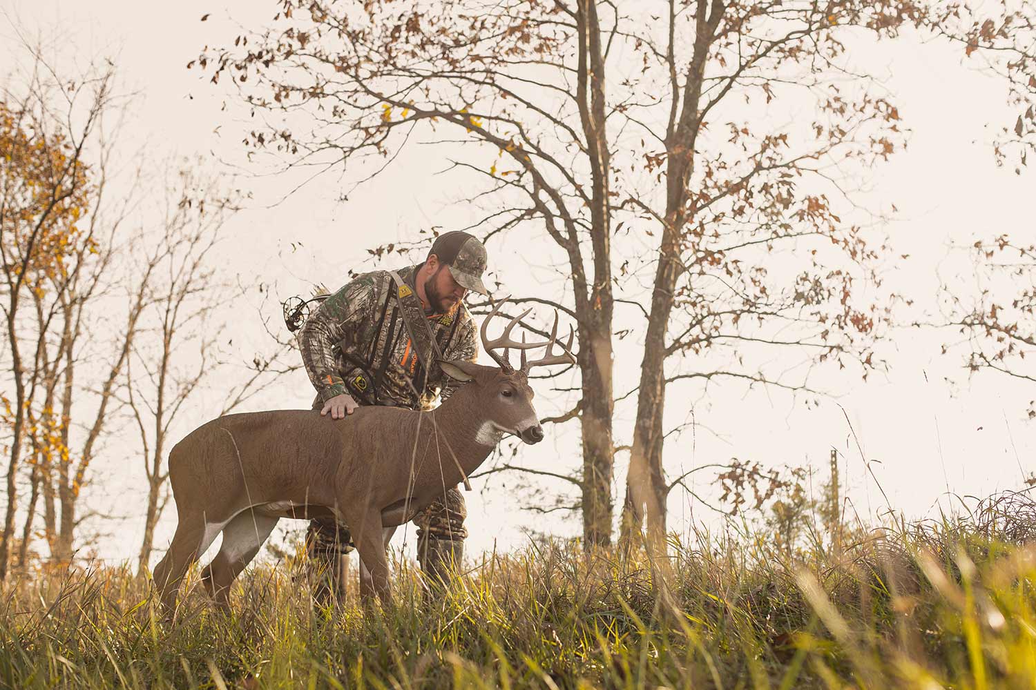Michael Hunsucker sets up a Dave Smith deer decoy on private land in Iowa.