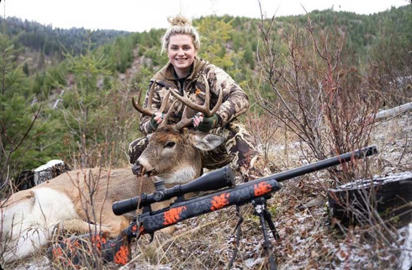 Female hunter with a whitetail deer.