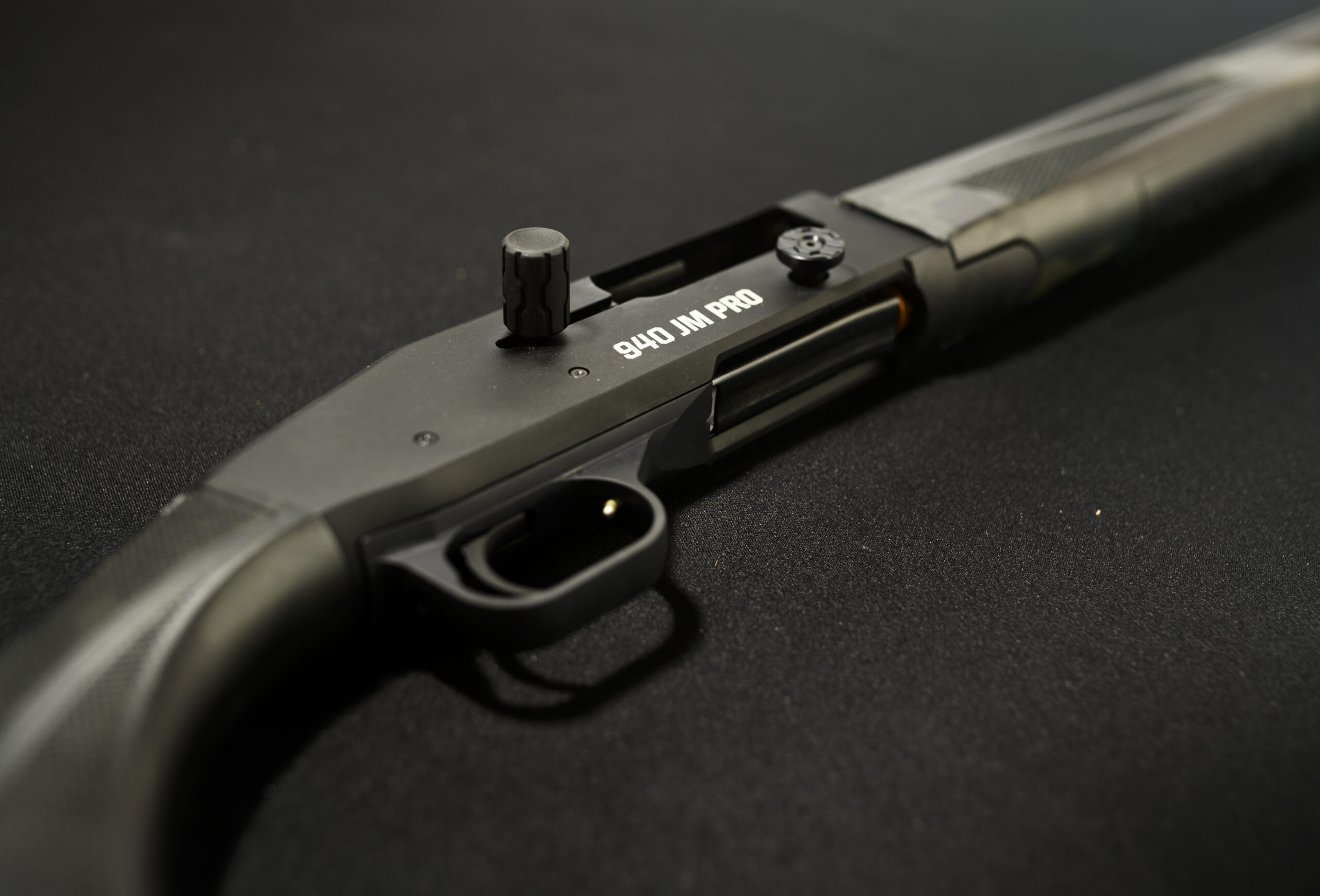 A semi-auto competition shotgun from Mossberg on a black background