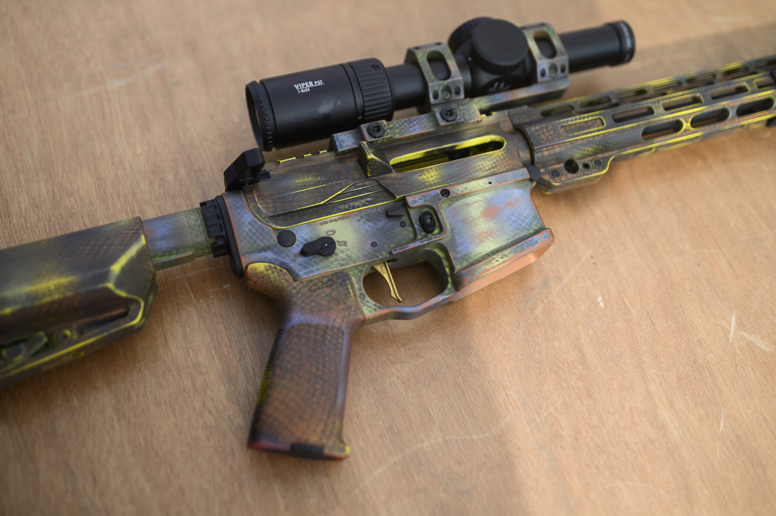 bight colored competition AR rifle topped with a Viper scope
