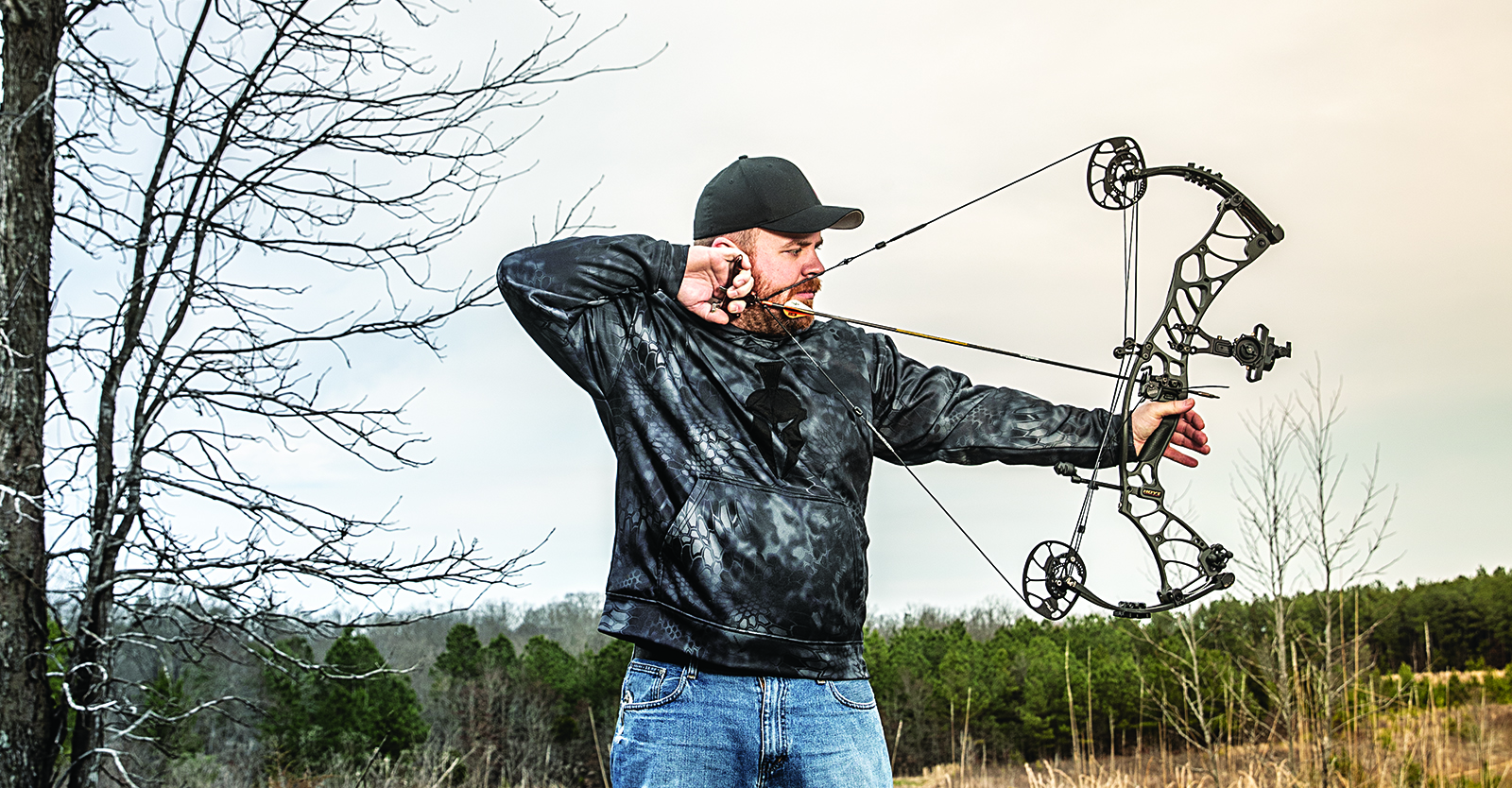 Bowhunter drawing back on a compound bow.