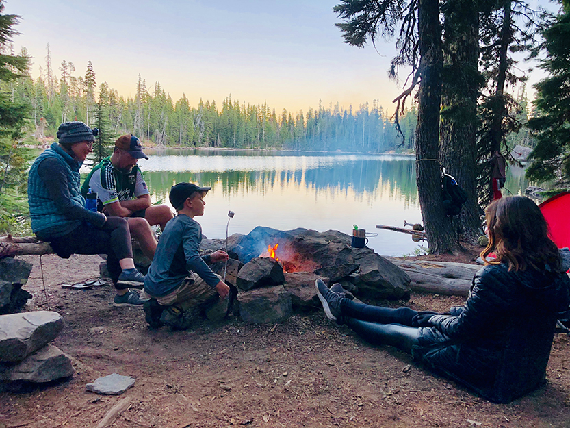 family sitting around a campfire