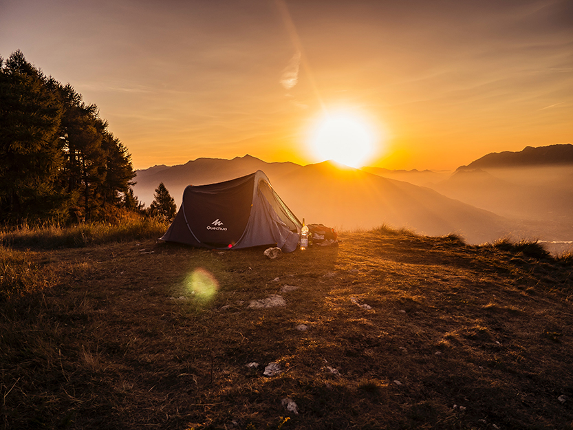 tent in front of a sunset