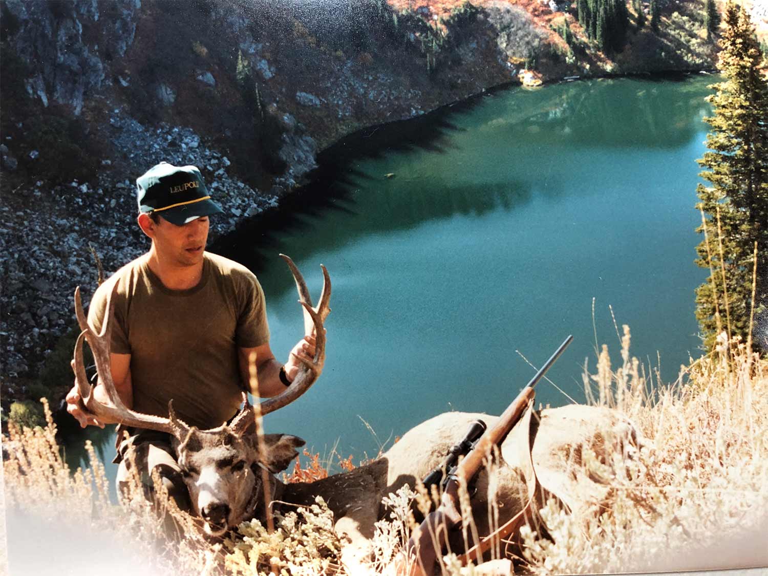 man posing with a large deer.