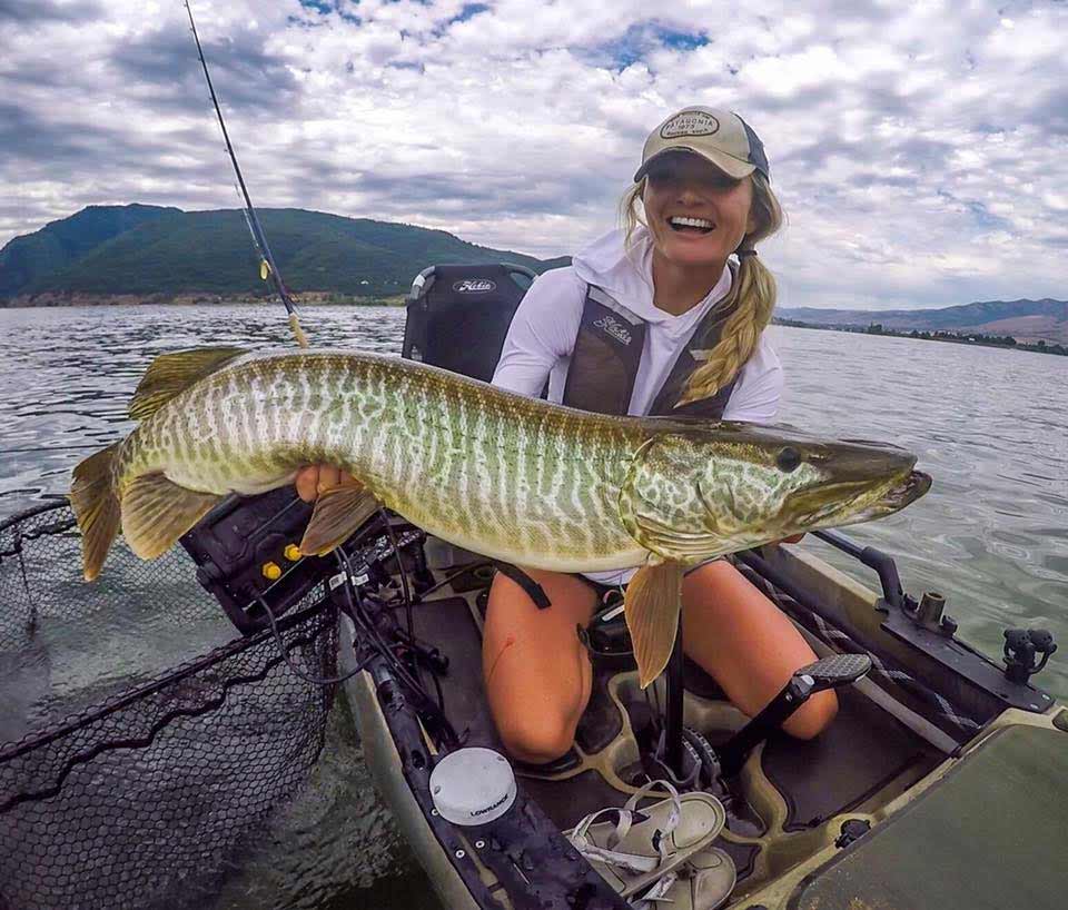 Woman holding a large musky.