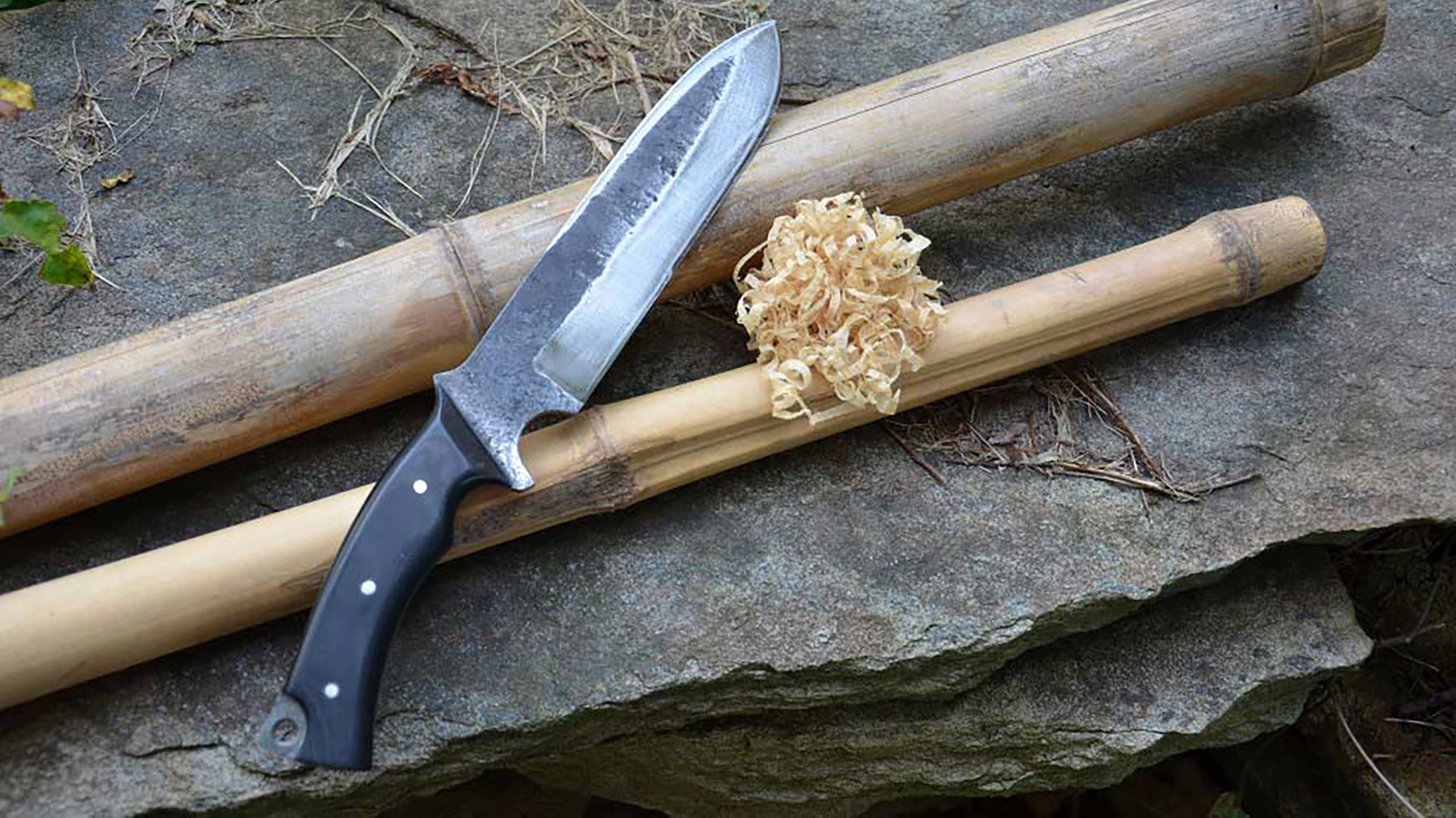 A knife shaving bamboo shoots.