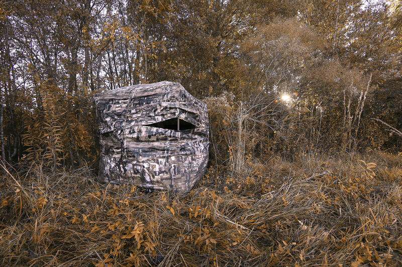 A camo Primos Double Bull Surroundview 360 groundblind on a field edge in the fall.