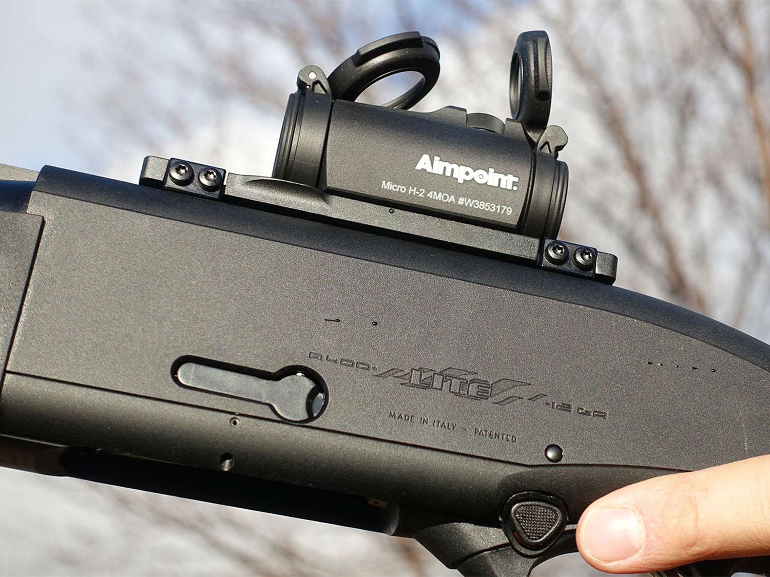 A red-dot sight mounted on a shotgun.