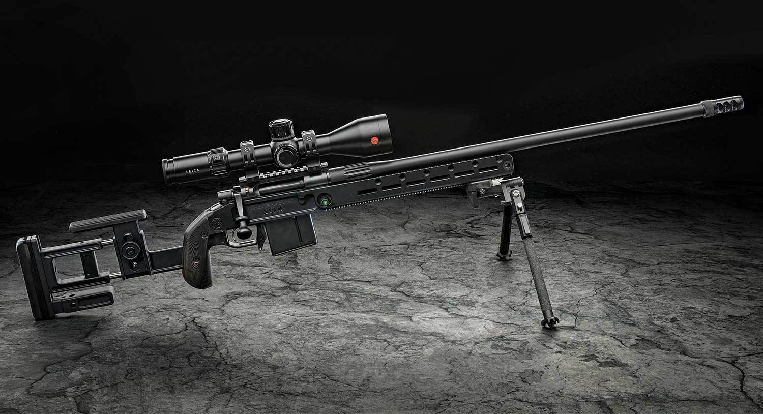 An American Rifle Company Nucleus Gen2 rifle on shooting sticks and a Leica Riflescope.