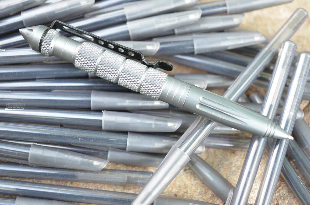 A collection of tactical pens on a table.