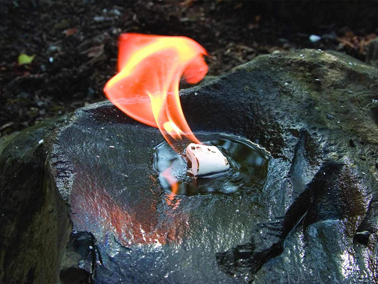 A WetFire cube in water on fire.