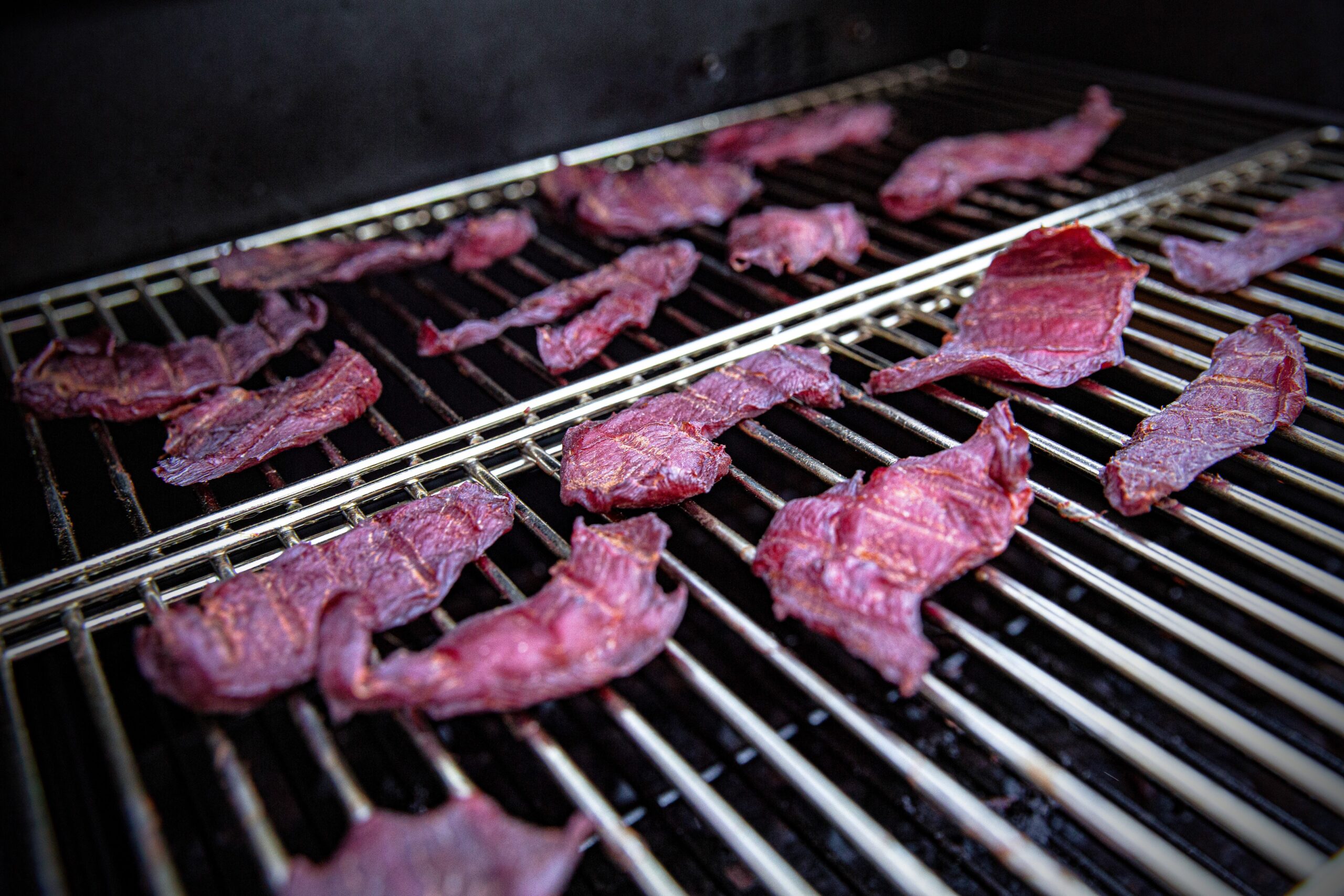 Smoked jerky is considered more flavorful, but using a dehydrator gives you more consistency in the texture of the meat.