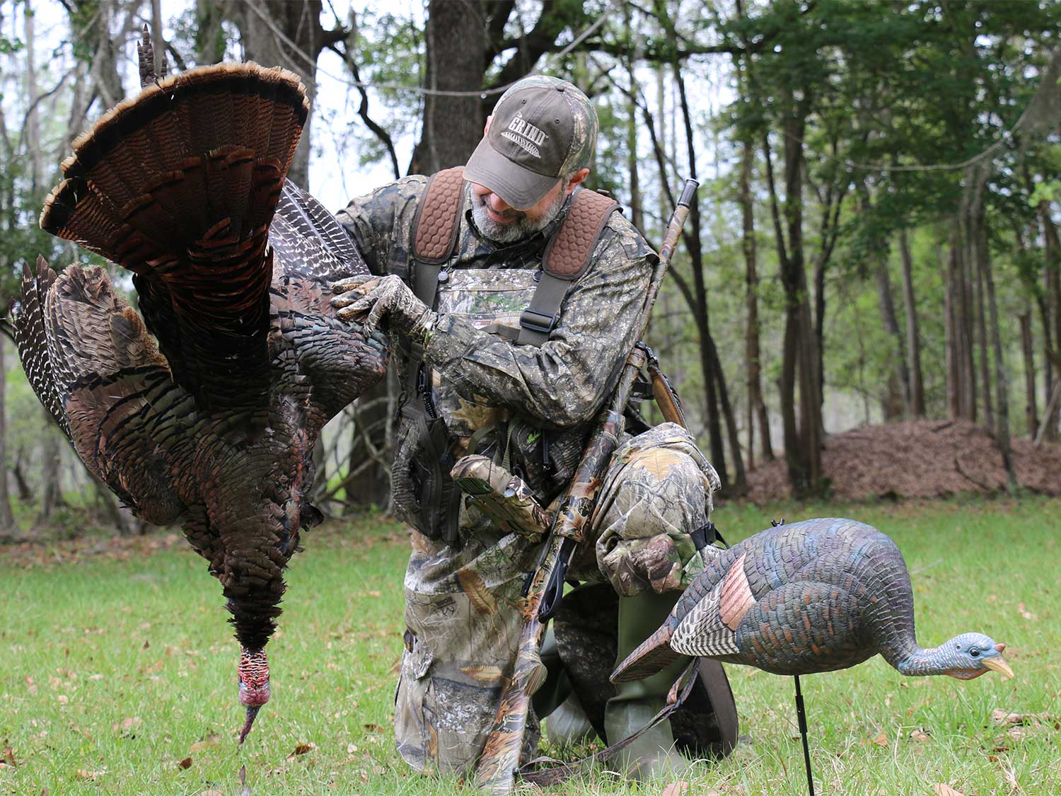 A hunter holds up a turkey next