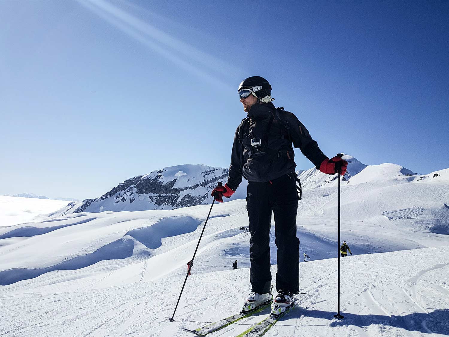 A man wearing skis and the best snow pants on a snowy mountain side.