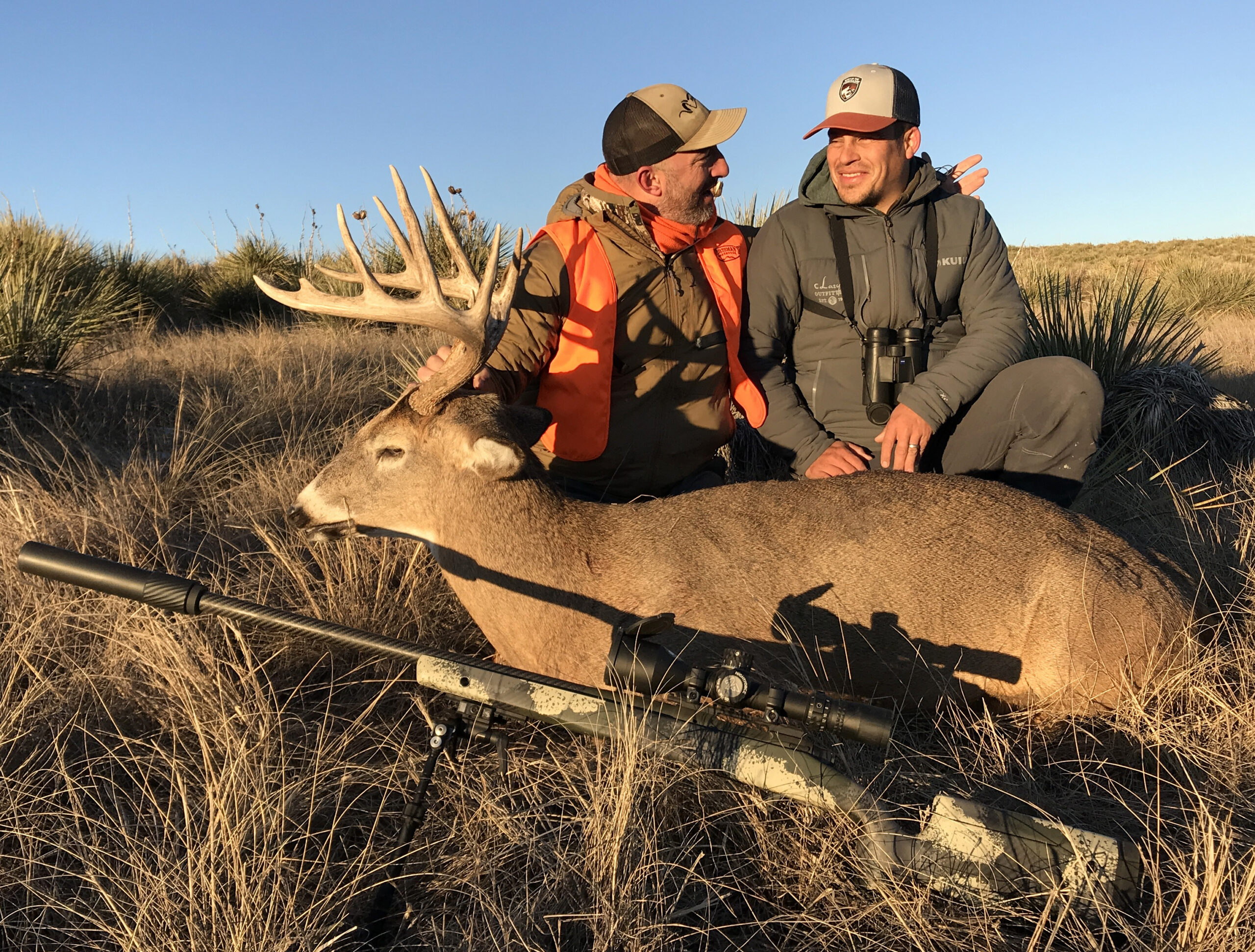 Two hunters sit behind a nice whitetail buck in Eastern Colorado.