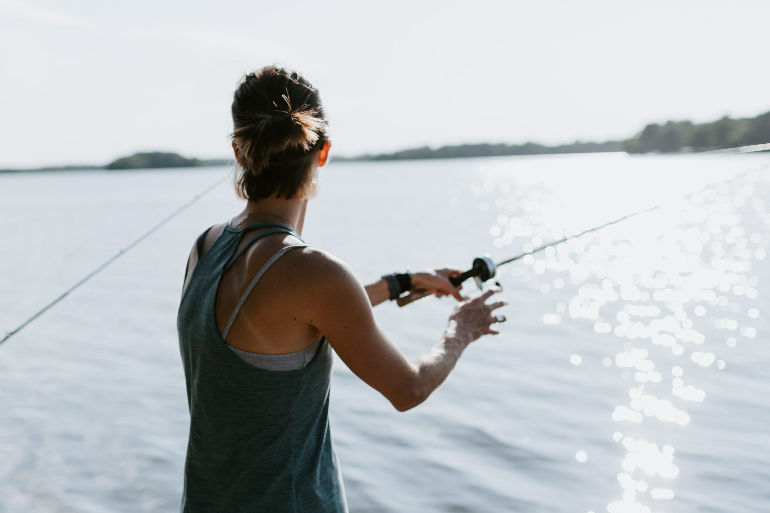fishing gifts for moms. woman fishing on a lake.