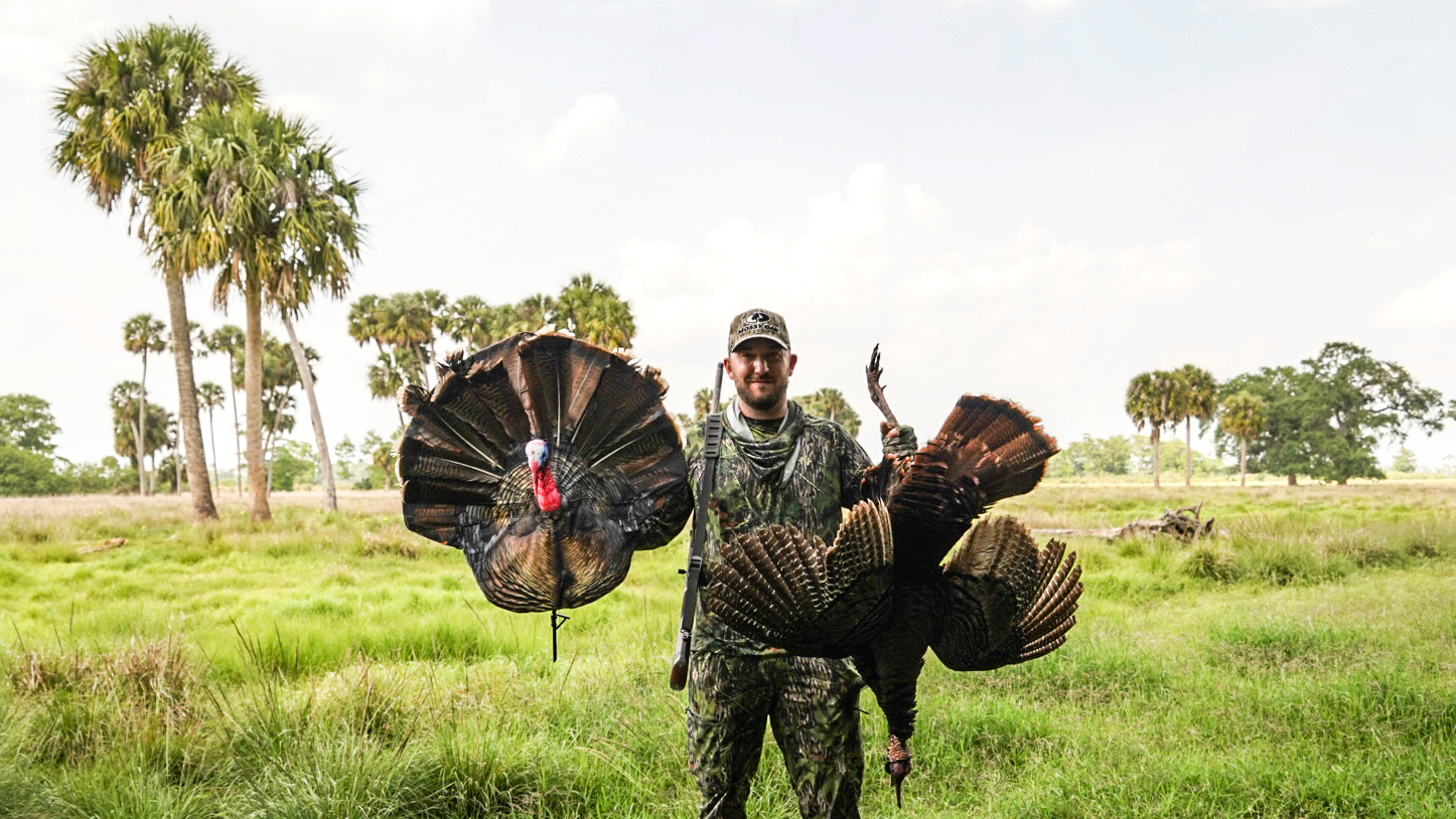 Hunter with a turkey and turkey decoy