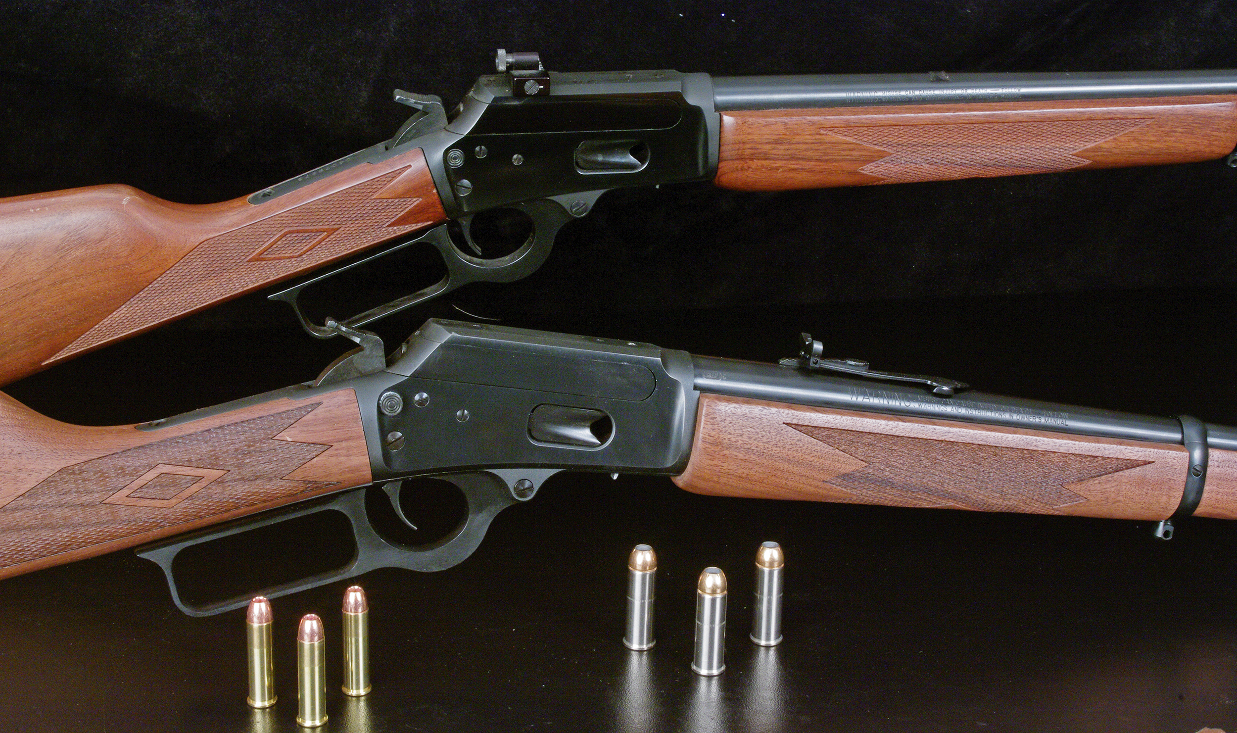 A pair of Marlin carbine rifles on a black background.
