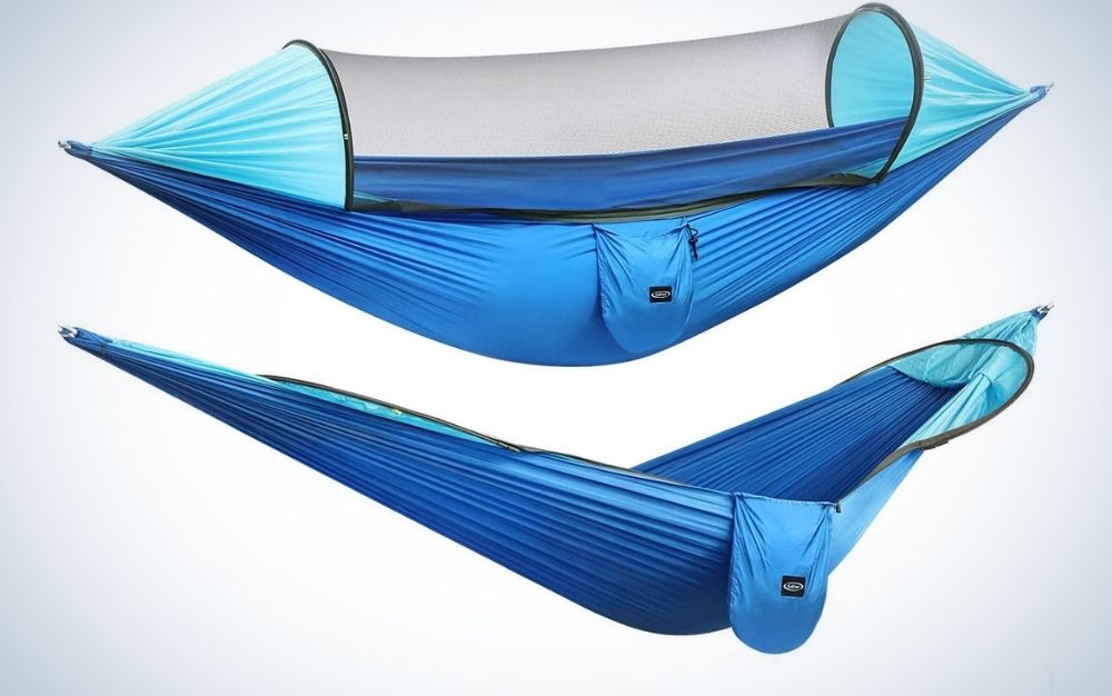 A blue large camping hammock with transparent mosquito parachute and a blue hanging hammocks tree straps swing hammock bed.
