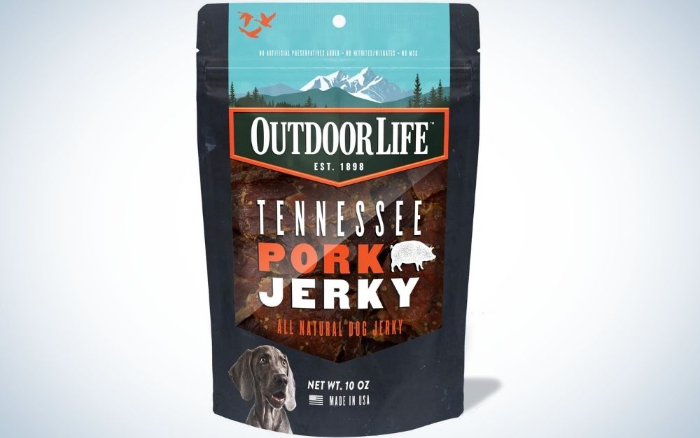 A black packing dog treat with mountain picture over it and with a descriptions Tennessee Pork Jerky food from Outdoor life.