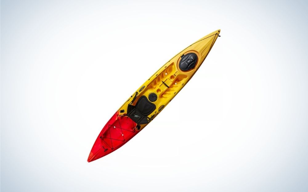 A yellow kayak with a red top and only one place to sit.