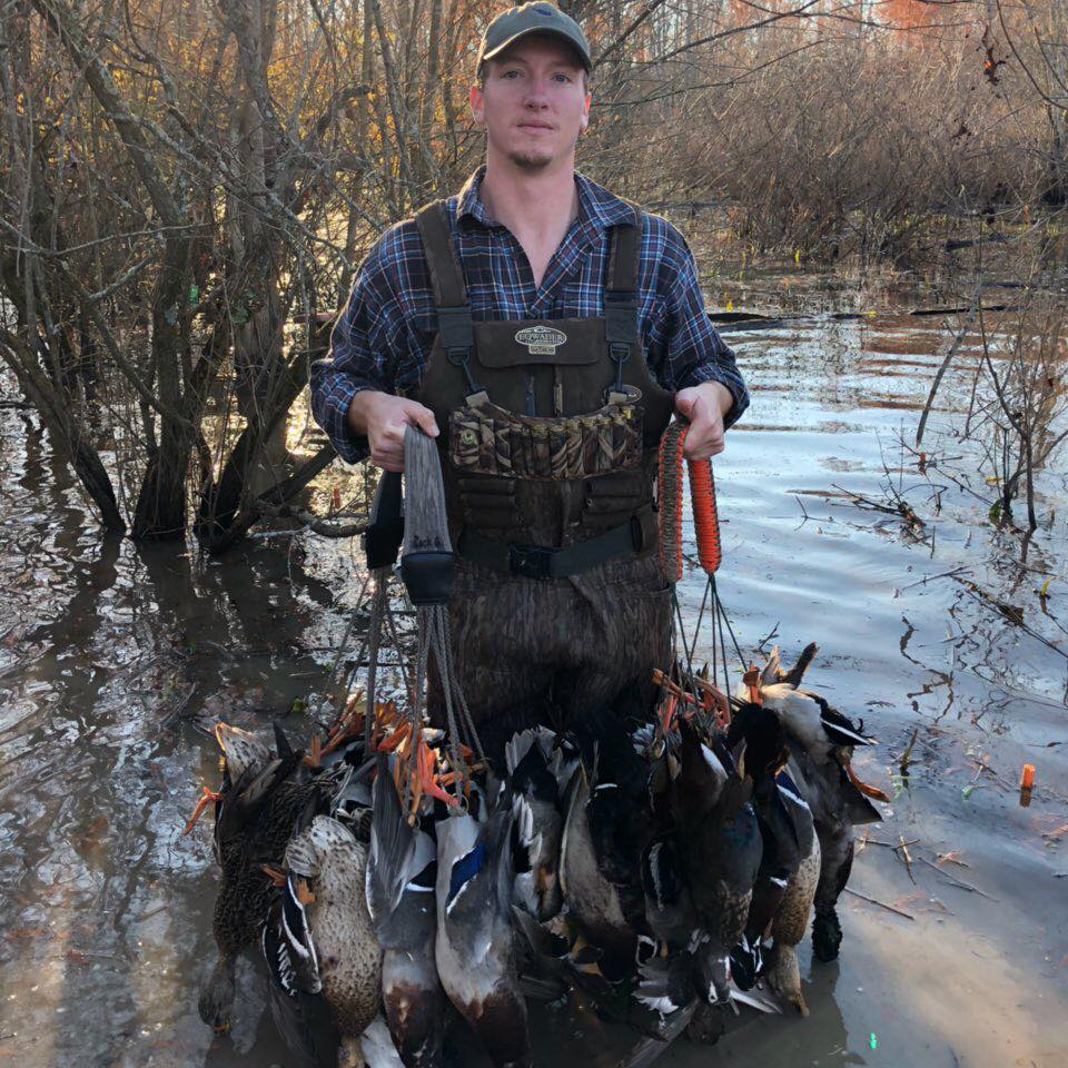 Zack Grooms with straps of ducks.