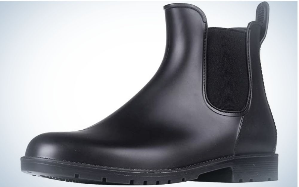 A black boot made entirely of leather material and with the elastic part on the side and a strong sole.