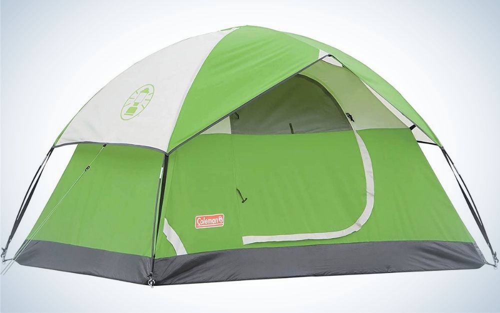 A green camping tent in white and with space inside completely enclosed.