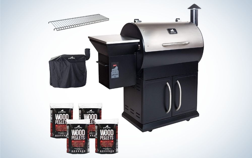 Silver and black electric wood pellet grill, with 4 bags of blend pellet fuel, a cover, and a upper rack extension